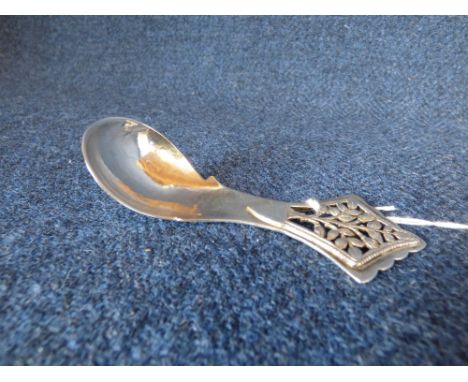 Modern design silver caddy spoon with hammered bowl, the handle pierced with a flowering shrub, maker 'John Murray' London 19