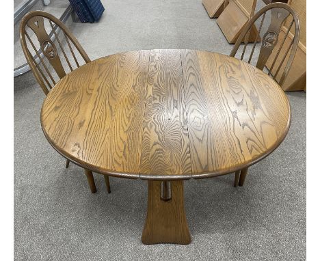 Modern Ercol oval gate leg table (121cm by 107cm) with two Ercol high back swan splat chairs
