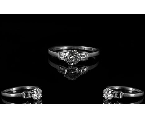 Ladies 1920's Platinum And Diamond Set Dress Ring The central diamond of good colour with inclusions flanked by two step cut 