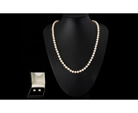 A Single Strand Cultured Pearl Necklace 6.5 mm pearls with 9ct gold clasp, 22 inches in length. Together with a pair of 9ct g