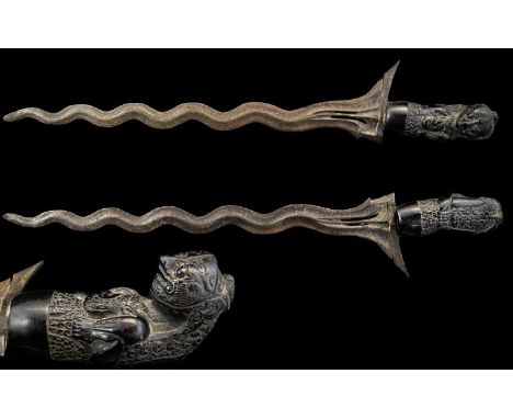 Indonesian 19th Century Long Bladed Kris Dagger with Hand Carved Figural Handle Damascus Steel Blade. Overall Length 17 Inche
