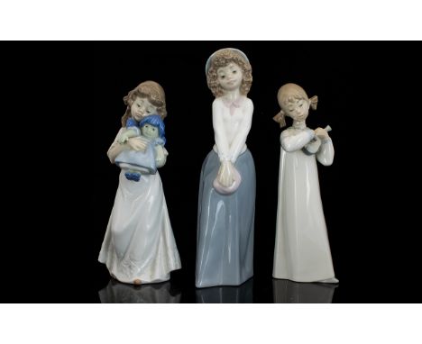 Lladro And Nao Porcelain Figures. Three Figures In Total (1) Little Girl With Rag Doll. (2) Little Girl With Violin (3) Littl