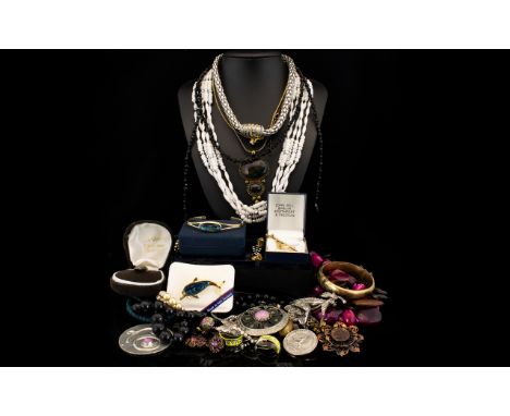 A Mixed Collection Of Costume Jewellery A varied lot to include various necklaces, beads, silver tone rope necklace, faux aga