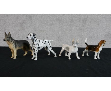 A Royal Doulton porcelain black and white standing dog, HN9113, together with a Beswick bisque porcelain Beswick dog, a Royal