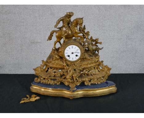 A late 19th/early 20th century gilded spelter mantle mantle clock surmounted with a soldier on horseback, the white enamel di