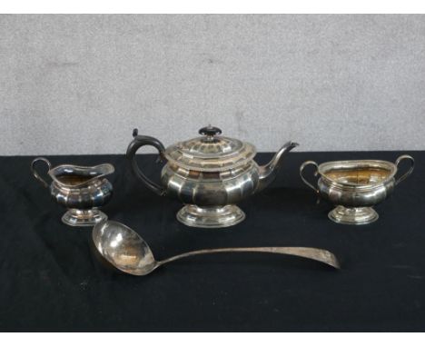 A 20th century silver plated three teaset together with a silver plated soup ladle. H.8 W.35 D.6cm largest 