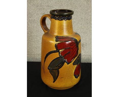 A mid 20th century West German pottery pitcher jug tubelined with floral decoration, marks to base. H.40cm. 