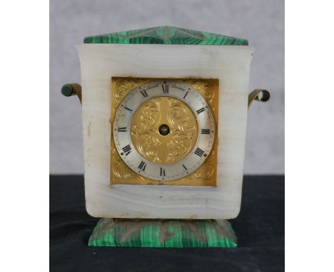An Art Deco marble and malachite Sewell of London mantle clock, with engraved brass and silvered dial raised on rectangular b