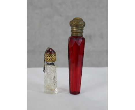 A 19th century tapering ruby glass and brass mounted scent bottle togther with a 19th century cut glass and brass mounted sce