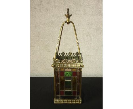 A late Victorian Arts &amp; Crafts brass and stained glass hanging hall lantern. H.63cm. 