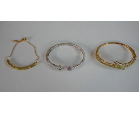 Two gem set bangles and a bracelet. One chrome pierced design bangle set with amethyst, peridot and Citrine, a gold plated pe