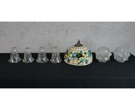 Assorted glass light shades to include a Tiffany style leaded glass light shade, a set of four Edwardian etched glass shades 