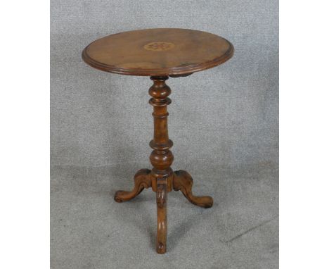 A 19th century circular inlaid walnut tripod table with turned central column raised on three cabriole supports terminating i