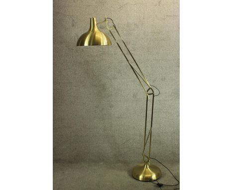A brass floor standing anglepoise adjustable lamp. 