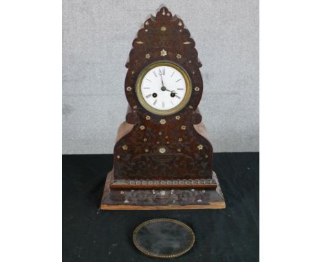 A 19th century carved Indian hardwood and inlaid mother of pearl mantle clock, the white dial with black painted Roman numera