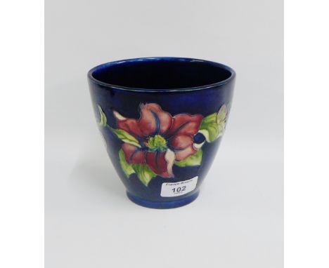 Moorcroft planter, the blue ground with flowers with facsimile signature, impressed marks and paper label, (a/f),  13cm high 