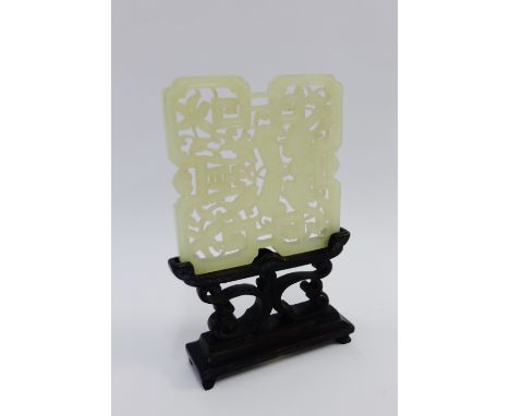Pierced jade plaque on a shaped hardwood stand, size overall 12cm 