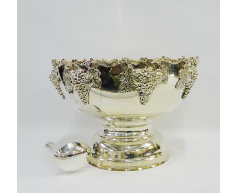 A large Epns punch bowl with fruit and vine pattern and on a circular pedestal base together with a ladle (2) 