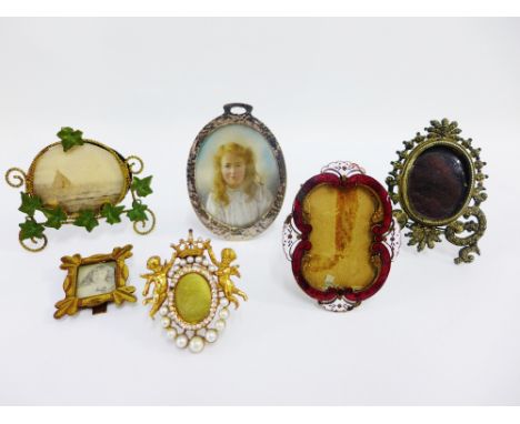 A collection of vintage miniature gilt metal photograph frames together with a portrait miniature on ivory of a young girl co