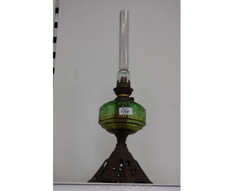 A Victorian Oil Lamp cast base with green glass