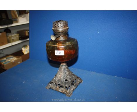 A Victorian Oil Lamp cast base with amber glass