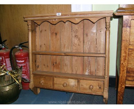 A stripped Pine spice rack having two shelves and three drawers below. 31" wide, 32 1/4" high.
