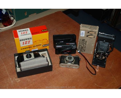 A boxed Brownie 127 Kodak Camera together with The Kershaw Eight-ZO Penguin Roll film camera