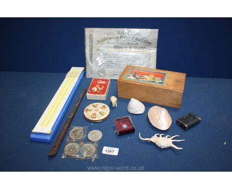 A quantity of miscellaneous to include a slide rule, a boxed Caithness miniature millefiori paperweight, shells, commemorativ