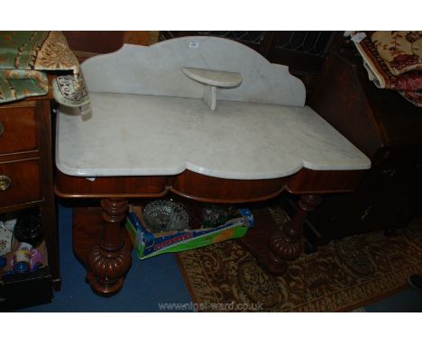 A Victorian Mahogany Washstand having veined white marble top and upstand incorporating small bow fronted shelf, the pot-boar