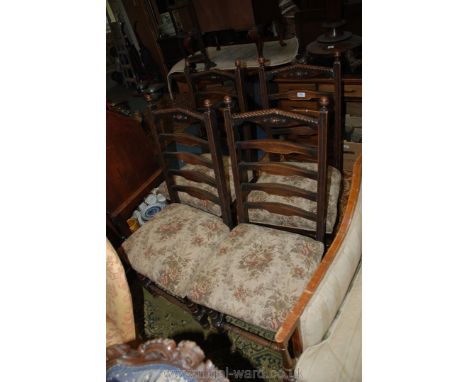 A Set of four Oak framed ladder back Dining Chairs having turned front legs and stretchers, the top rail with rope detail and