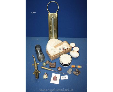 Miscellaneous items including a brass toffee thermometer, nut crackers, china egg, glass eyes, etc.