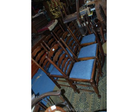 A set of six mixed dark wood framed Ladder back Dining Chairs having blue upholstered drop-in seats.