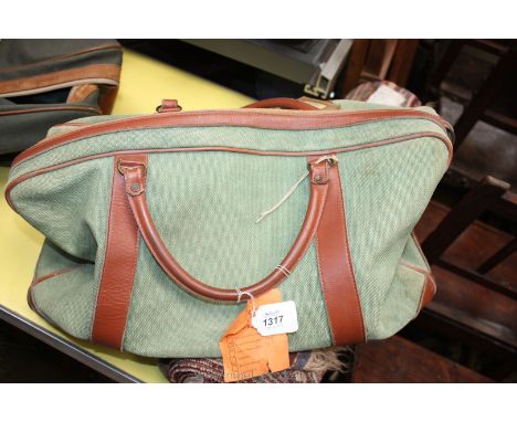A small light green canvas and tan leather travel Bag