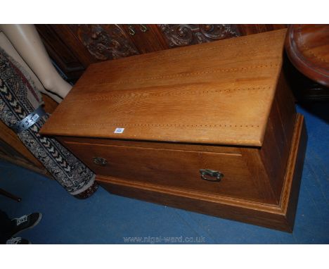 A low medium Oak single drawer Chest/Blanket Box having drop-in top and featuring unusual light and dark wood string decorati