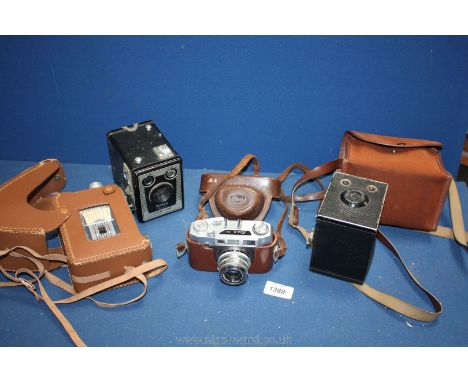 Two Brownie cameras, one in case and a Pal Mk 4 camera in a case and a Brownie 8mm camera