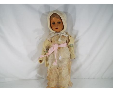 An early period doll acquired from Singapore in 1946, sleeping eyes, open mouth with upper teeth, light brown wig, period lac