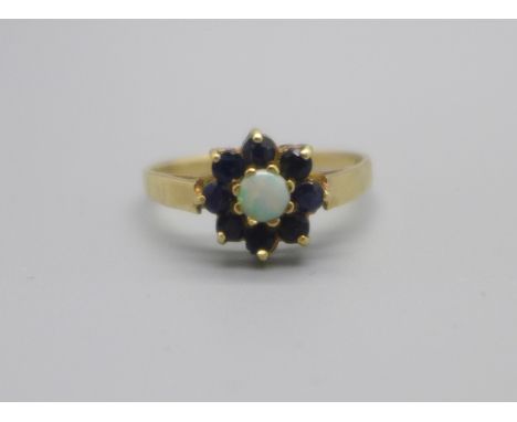 A 9ct gold ring, set with sapphires and a central opal, 1.7g, N 