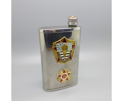 A vintage Soviet spirit flask mounted with two enamel badges 