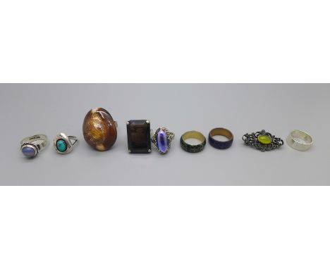A collection of white metal and silver rings, including native American silver Navajo ring set with turquoise 