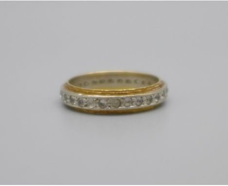 An 18ct gold full eternity ring, set with clear stones, 3.6g, M 