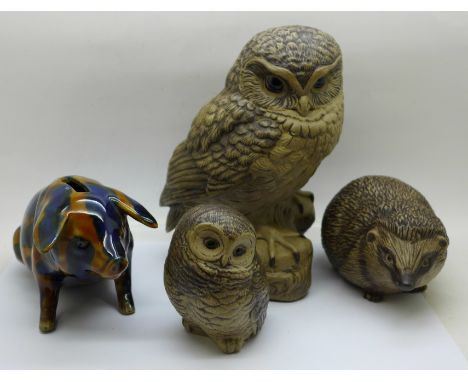 Two Poole pottery owls, the largest signed, a Poole hedgehog and a pig money bank 
