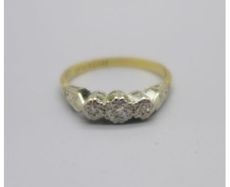 An 18ct gold and platinum set three stone diamond ring, 2.1g, M 