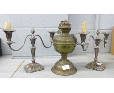 Two silver plated candelabra and an oil lamp base  **PLEASE NOTE THIS LOT IS NOT ELIGIBLE FOR POSTING AND PACKING** 
