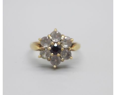 A 9ct gold daisy ring set with garnet and white stones, 2.8g, M 