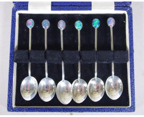 Cased set six Australian opal set coffee spoons marked 'sterling silver,' with opal set to each finial. Weight 44grams approx