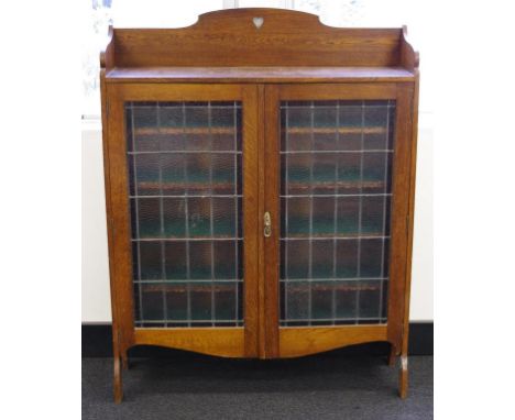 Arts and Crafts era oak bookcase lead light doors with adjustable shelves. Key available. 113cm wide, by 30cm deep, and 148cm