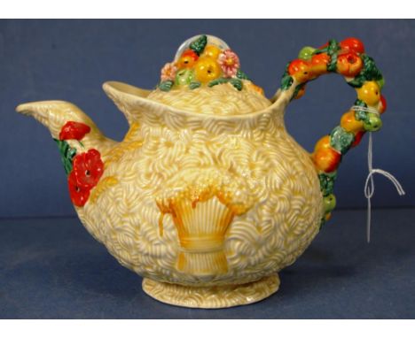 Clarice Cliff 'Celtic Harvest' teapot embossed fruit and wheat sheaf decoration, marked to base, and Newport Pottery Co. Heig