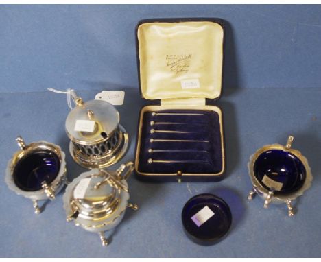 Three piece silver plate condiment set including 2 open salts and a mustard pot, each with blue glass liner; another silver p