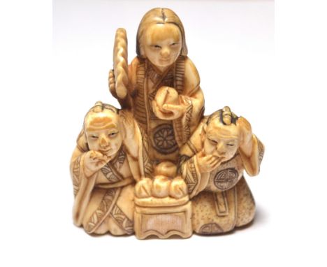 Chinese carved bone netsuke in the form of three figures in a group