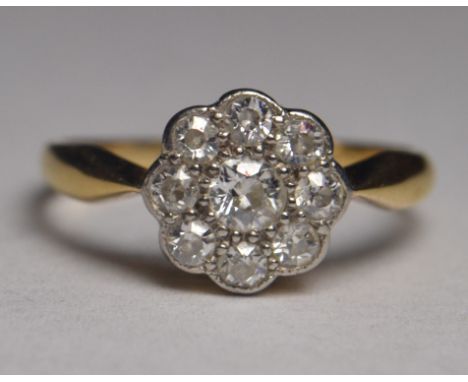 Yellow metal ring set with flower head design cluster of 9 diamonds (unstamped) in box